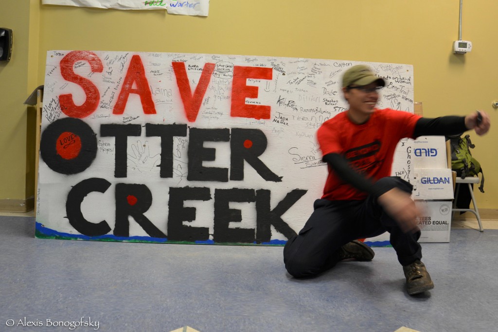 Kaden Jarey mans the Save Otter Creek sign at the Inter-tribal No Coal Gathering in Lame Deer. March 2013. 